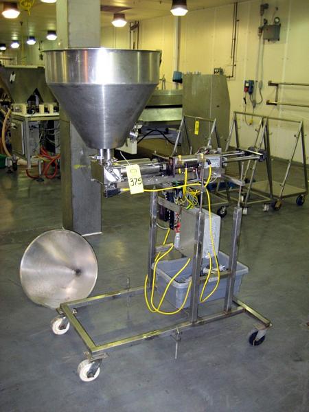positor, Ser. #DF594, 110 volts, single phase, 90 PSI on s.s. frame on wheels  w/s.s. hopper & spare