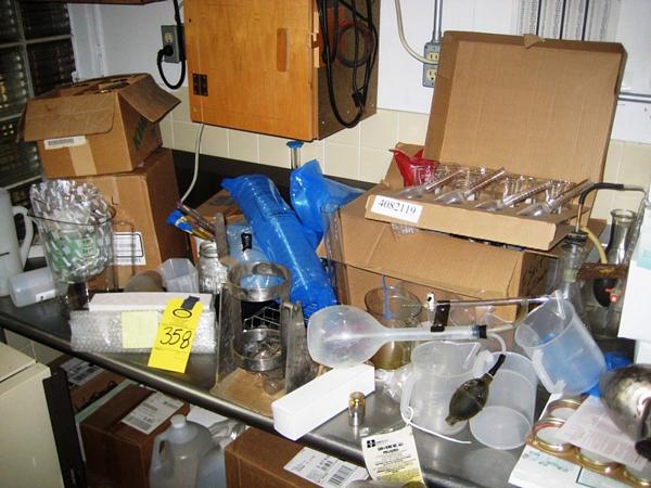 , including acid bottles, beakers, pipettes, & misc. hot boxes on wall