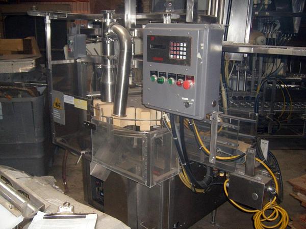 Filler, designed to fill 5 1/2" diameter round containers, 12 container pockets on rotary turn