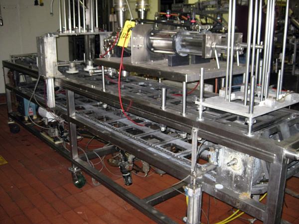 dual piston fillers & press on lidder, on s.s. frame, set up for 4" X 5 3/4" tray